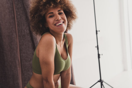 Photo of lovely young lady cheerful smile dressed khaki lingerie studio background no filter self acceptance all body perfectの写真素材