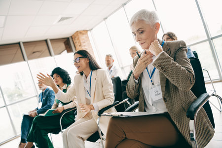 Diverse team in a contemporary business meeting, engaged individuals contributing ideas and discussion in a collaborative workspaceの写真素材