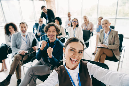 Group of professionals in a lively meeting capturing a moment of joy while collaborating together in an office environmentの写真素材