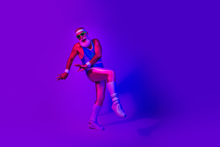 Dynamic retro fitness man jumps in neon purple blue studio wearing a jumpsuit and headband for a vibrant lifestyle imageの写真素材