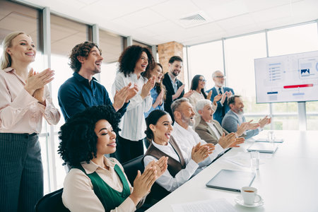 Diverse Office Team Clapping During a Presentation in a Modern Workplace Celebrating Success and Collaborationの写真素材