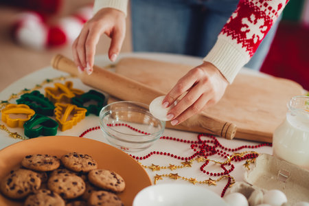 Funny cheerful kitchen scene Christmas baking with cookies rolling pin beads and cozy home holiday moodの写真素材
