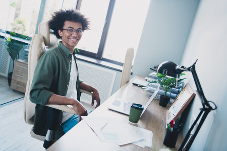 Photo of clever intelligent manager wear khaki shirt glasses working modern device indoors workshop...