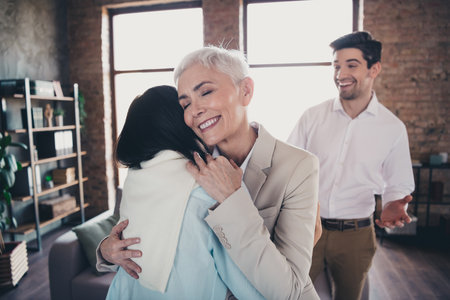Portrait of group friendly corporate coworkers toothy smile cuddle loft interior modern office indoorsの写真素材