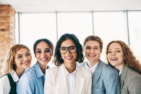 Diverse group of professionals collaborating in a modern office environment, showcasing teamwork and...