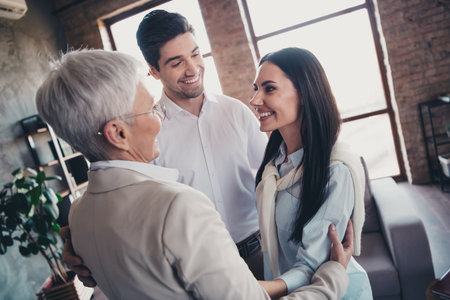 Portrait of group friendly corporate coworkers embrace speak loft interior modern office indoorsの写真素材