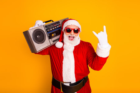 Santa boombox on orange background celebrates Christmas holiday fun perfect festive marketing campaigns seasonal promotionsの写真素材