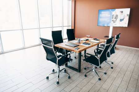 Professional office meeting room with modern furniture and presentation display set up for business discussionsの写真素材