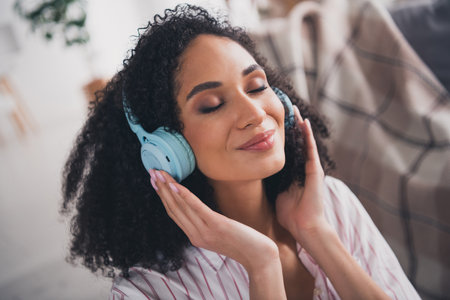 Photo of dreamy sweet lady wear white shirt earphones listening songs indoors room home houseの写真素材