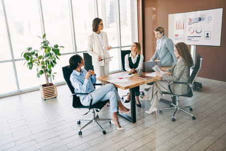 Professional business team collaborating in a modern office environment with a focus on innovation and teamworkの写真素材