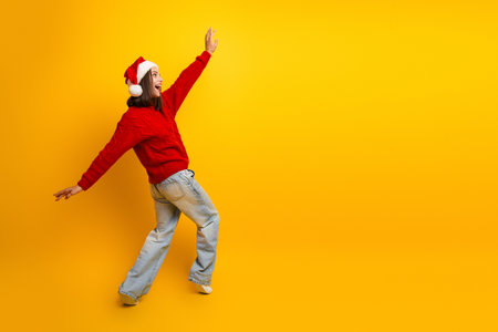 Playful santa hat moment jumps into holiday joy for Christmas cheerの写真素材