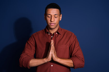 Photo portrait of attractive young man pray meditate closed eyes dressed stylish brown clothes...