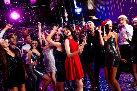 Funny creative party vibes at a stylish nightclub with dancing friends celebrating Christmas and New...