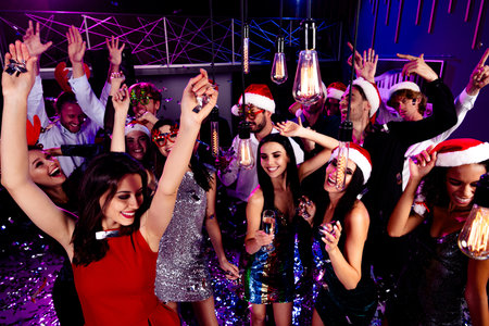 Fun holiday party dance floor celebration with friends at a neon club and festive outfits