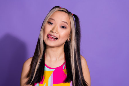 Photo of lovely adorable cute girl wear trendy clothes isolated on purple color backgroundの写真素材