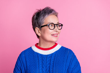 Photo of nice aged lady look empty space wear blue sweater isolated on pink color background