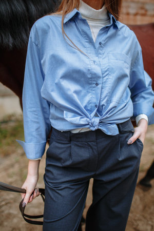 Girl rider standing next to a horseの写真素材
