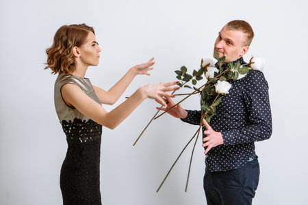 The girl throws the roses given to her at her boyfriend.