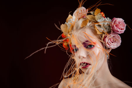 A girl with lively curly hair and flowers in her head. Art object. Flower girl fairyの写真素材