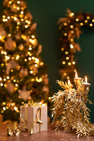 christmas background with candles, golden ornaments and a gift boxの写真素材