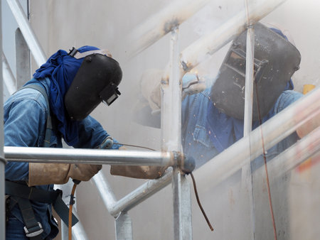 Welding work, worker with protective welding metal on construction