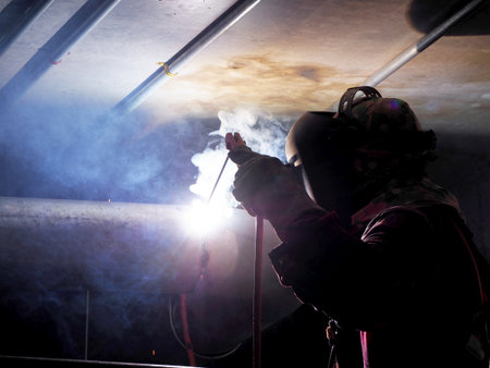 Welding work ,worker with protective welding metal on construction