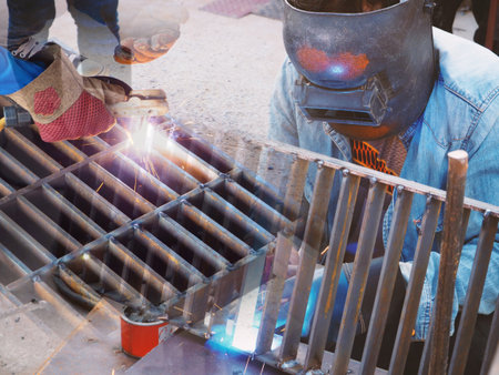 Welding work ,worker with protective welding metal on construction