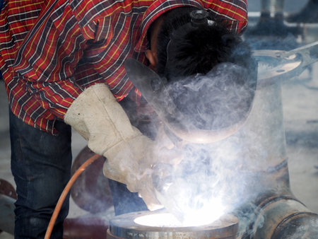 Welding work ,worker with protective welding metal on construction