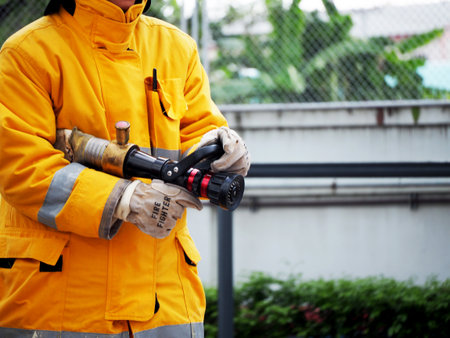 firefighter training., fireman using water and extinguisher to fighting with fire flame in an...