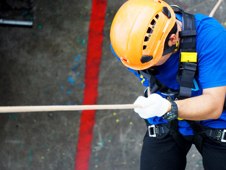 Firefighters are rappelling and climbing ropes at a drill exercise