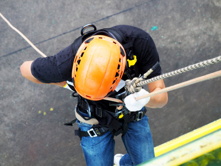 Firefighters are rappelling and climbing ropes at a drill exercise