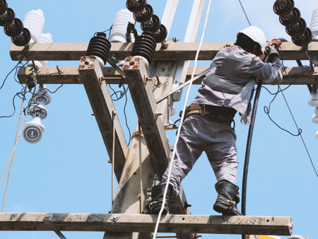 electrician man working at height and dangerous ,high voltage power line maintenanceの写真素材
