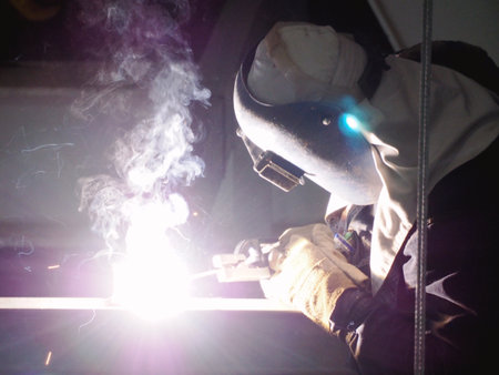 Welding work ,worker with protective welding metal on construction