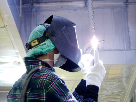 Welding work ,worker with protective welding metal on construction