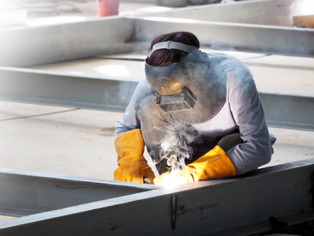 Welding work ,worker with protective welding metal on construction