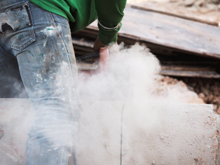 Worker grinds the concrete of angular grinding machineの写真素材