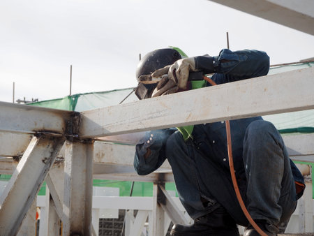 Welding work ,worker with protective welding metal on construction