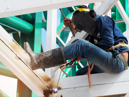 Welding work ,worker with protective welding metal on construction