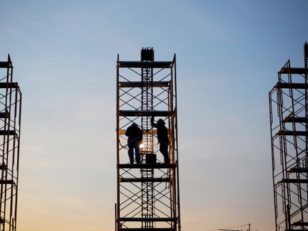 Man Working on the Working at height on construction site with blue sky