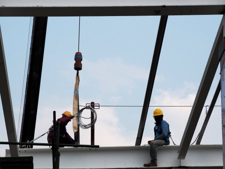Man Working on the Working at height on construction site with blue sky