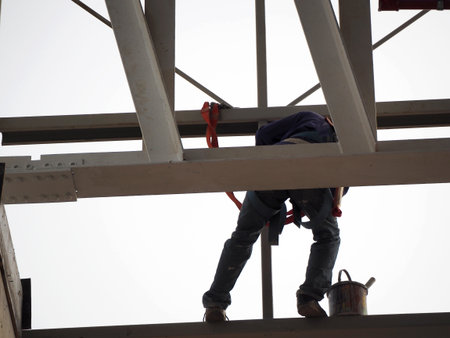 Man Working on the Working at height on construction site with blue skyのeditorial素材