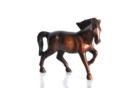 Horse carved out of wood at the white backgroundの写真素材