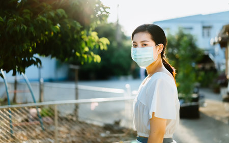 Beautiful Asian woman wearing a face mask at outdoor ,To prevent the virus Covid-19 pandemic, stay safe and social distancing concept for protect from Corona virus, PM 2.5, New normal behaviorの写真素材