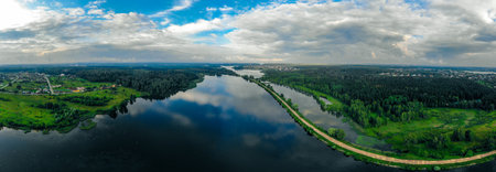 panorama from a drone of a blue river and green forest