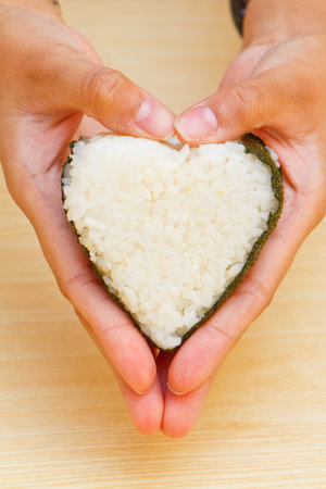 rice with heart on handの写真素材