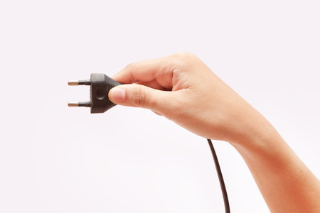 hand holding plugの写真素材