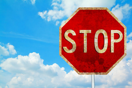 old Grunge rusty traffic sign on the blue sky 