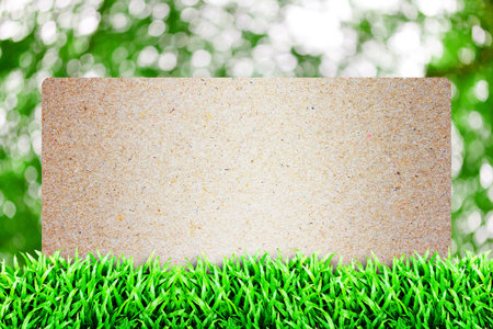 Old paper in the Grass field and cloudy sky background の写真素材