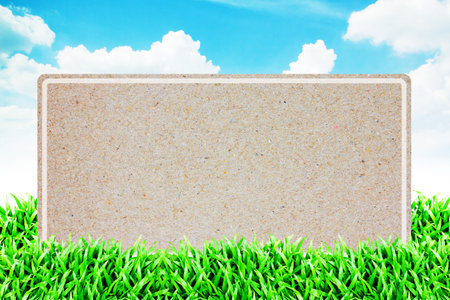 Old paper in the Grass field and cloudy sky background の写真素材