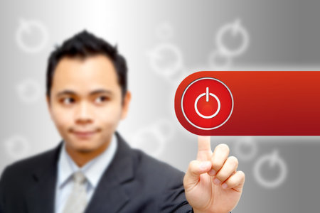 Business man press red power buttonの写真素材
